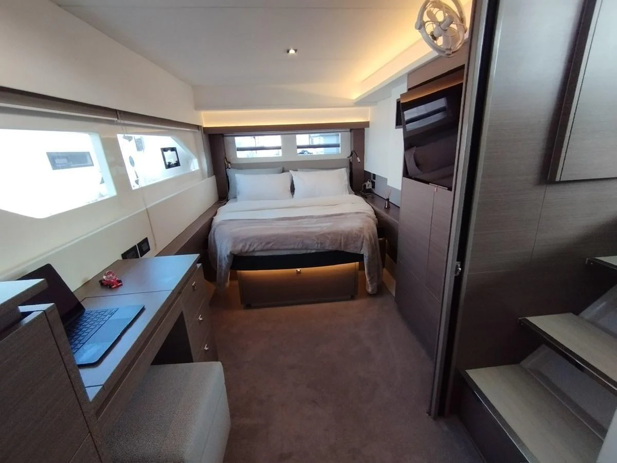 A cozy and modern stateroom featuring a comfortable bed and ample natural light. aboard LEOPARD 28M Yacht for Sale