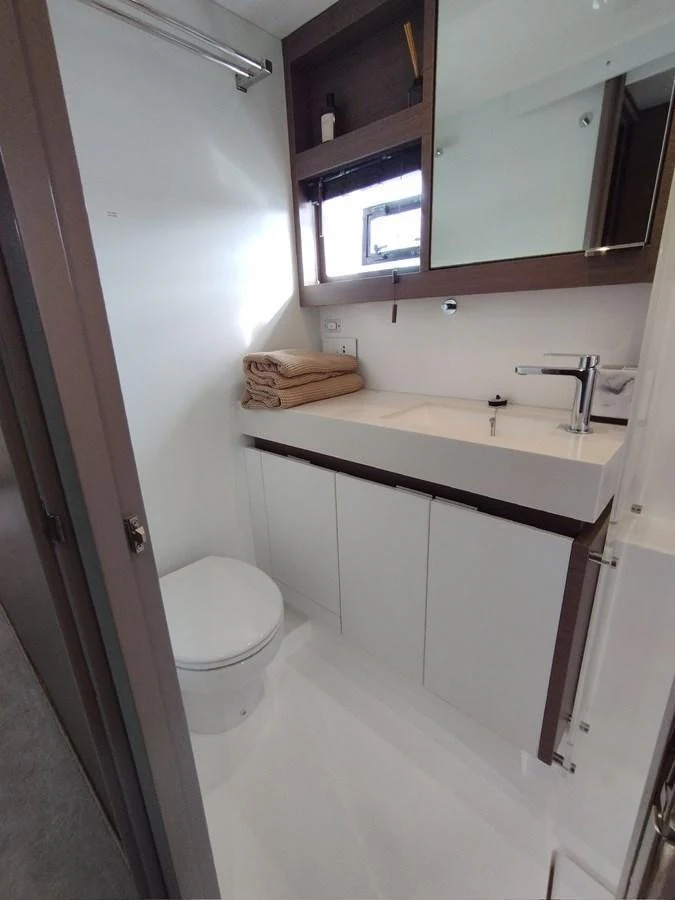 The yacht's head features a sleek and modern design with ample storage and a clean aesthetic. aboard LEOPARD 28M Yacht for Sale