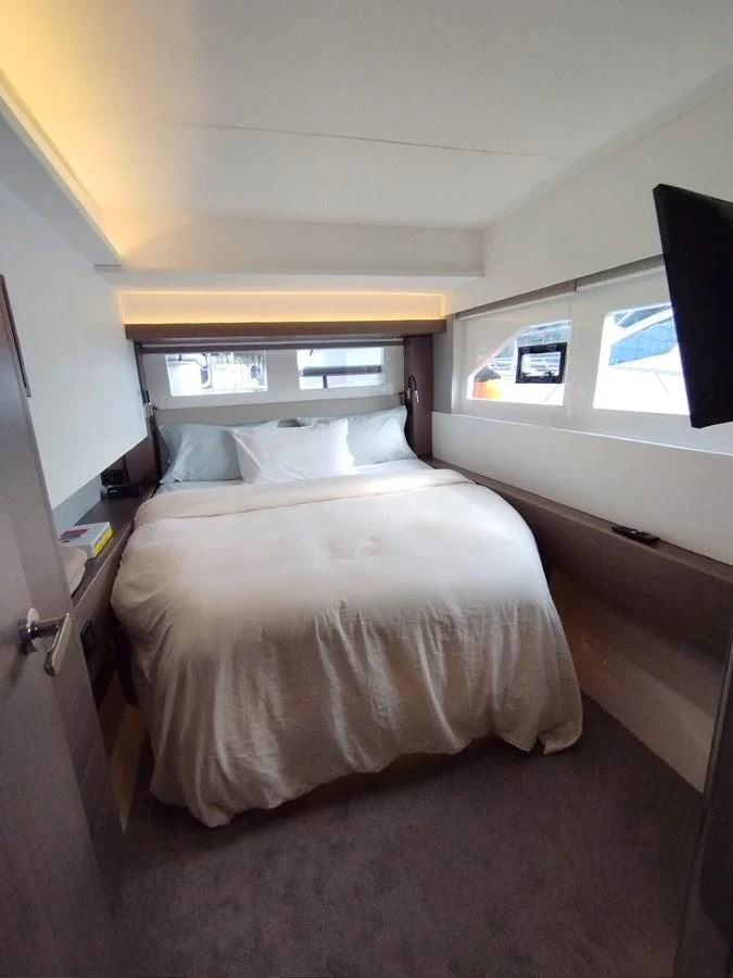A cozy stateroom with a comfortable bed and ample natural light. aboard LEOPARD 28M Yacht for Sale