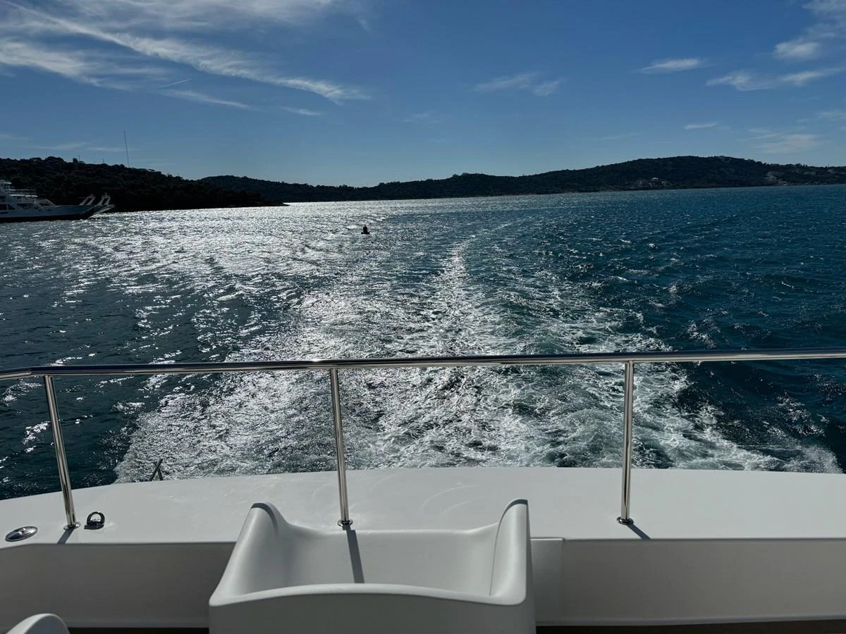A serene view from the yacht's deck, overlooking the sparkling water and distant shoreline. aboard LEOPARD 28M Yacht for Sale