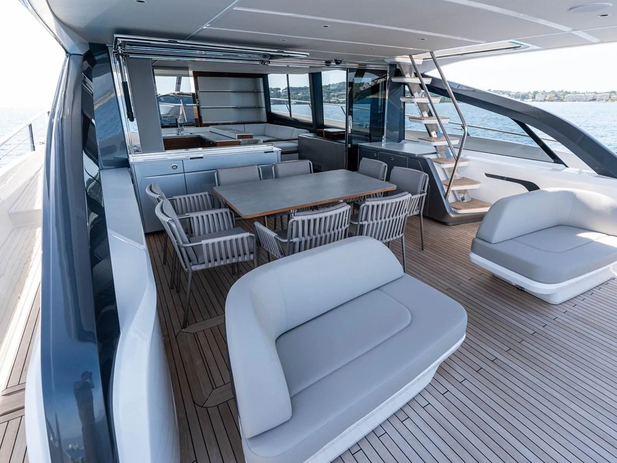 a room with a table chairs and a ladder aboard PRINCESS S80 Yacht for Sale