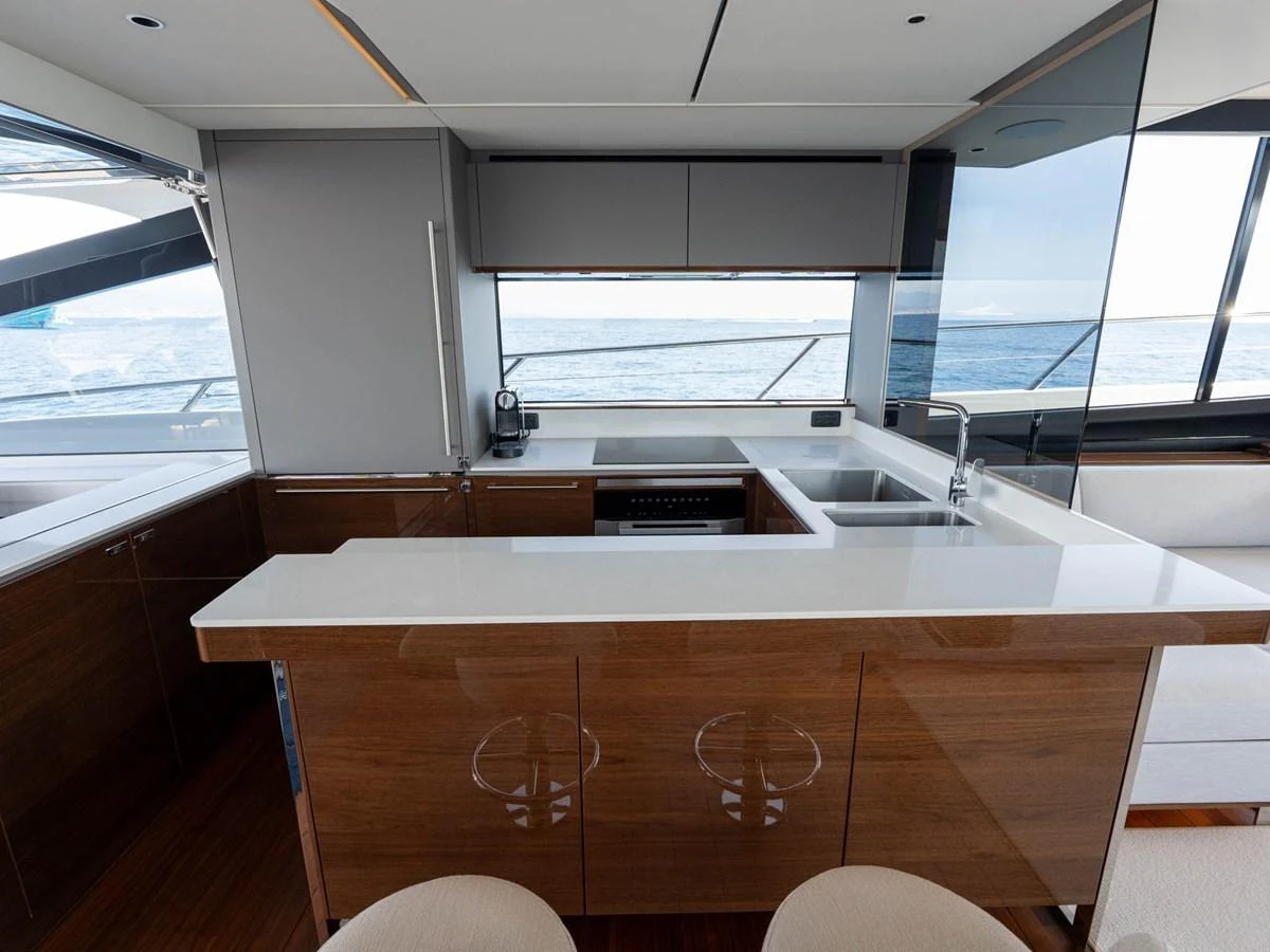 a kitchen with a large window aboard PRINCESS S80 Yacht for Sale