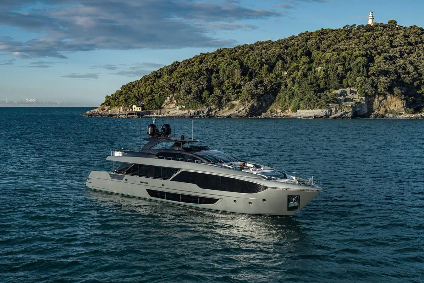 A sleek, modern yacht cruises gracefully on calm waters with a scenic coastal backdrop. aboard RIVA 112 DOLCEVITA SUPER Yacht for Sale