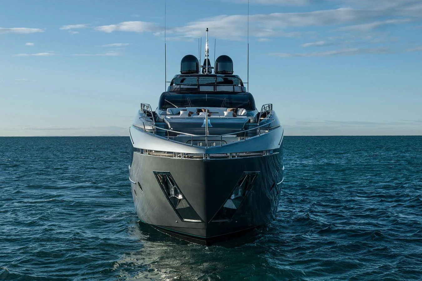 A sleek and modern yacht cruising on calm waters under a clear sky. aboard RIVA 112 DOLCEVITA SUPER Yacht for Sale