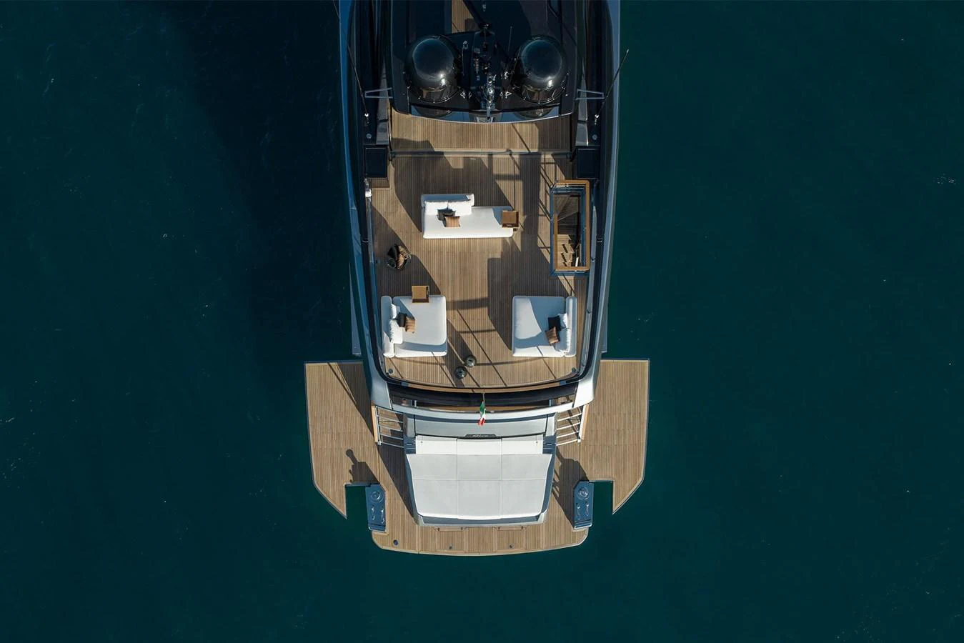 The aft deck offers a spacious and inviting area for relaxation and socializing, with elegant seating arrangements and a stunning view of the water. aboard RIVA 112 DOLCEVITA SUPER Yacht for Sale