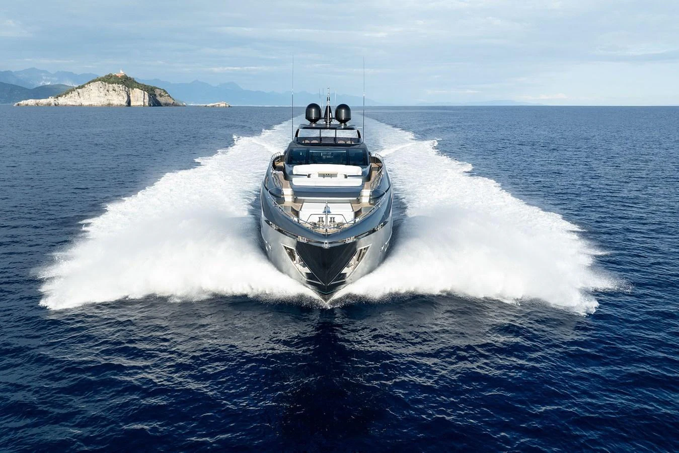 A sleek yacht cruises powerfully through the open sea, leaving a dramatic wake behind. aboard RIVA 112 DOLCEVITA SUPER Yacht for Sale