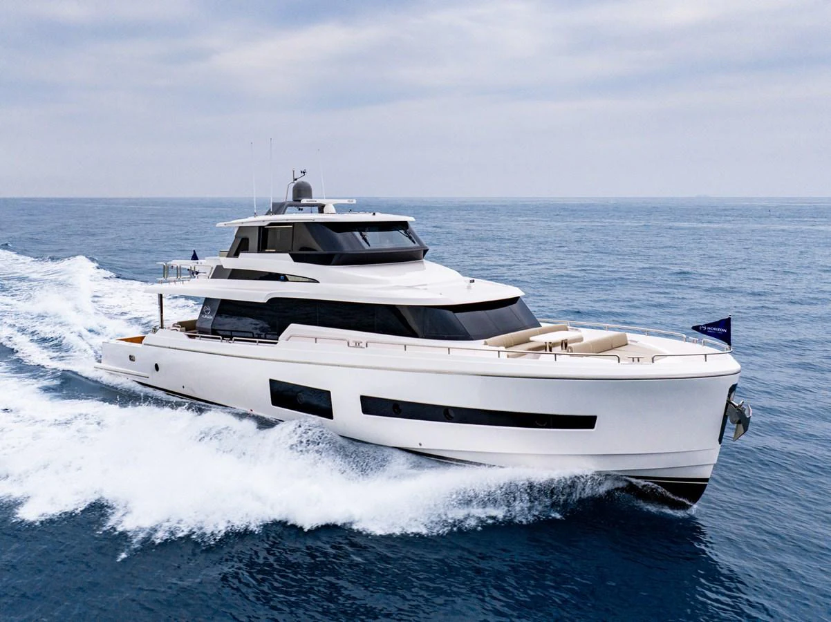 a white yacht on the water aboard HORIZON V77S Yacht for Sale