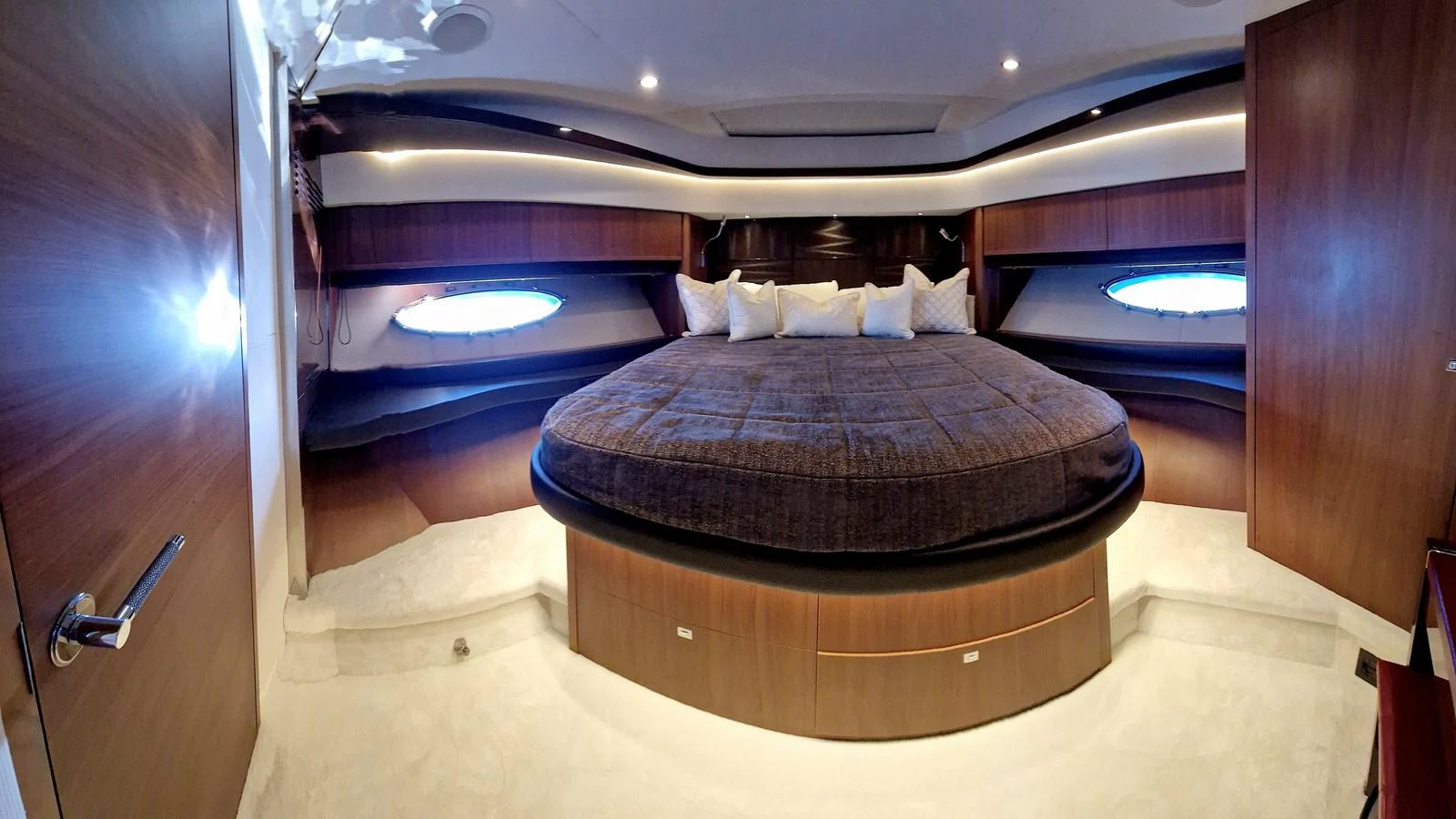 The master stateroom features a luxurious circular bed with elegant wood paneling and ambient lighting. aboard GIA GIA' Yacht for Sale