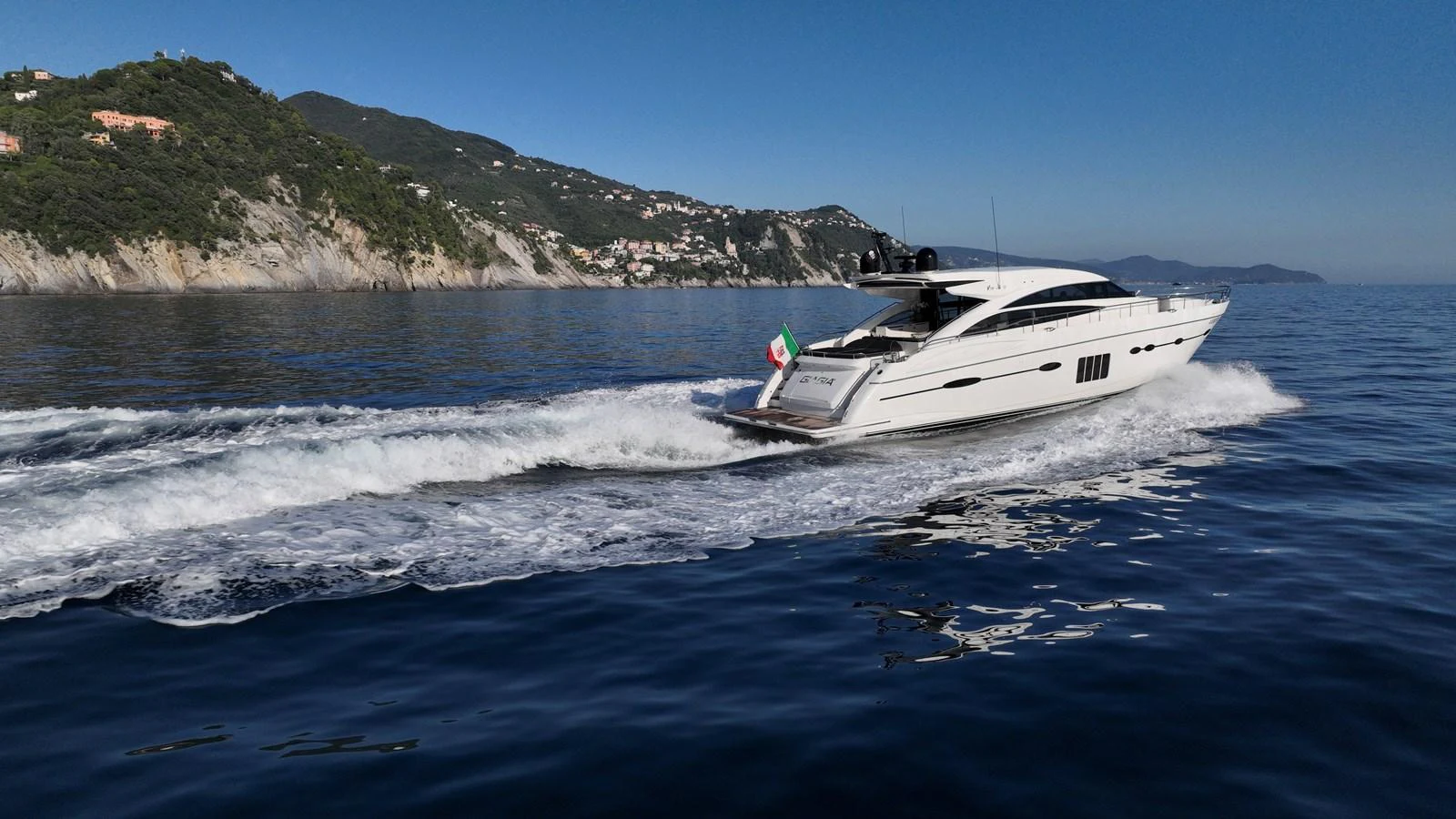 A sleek yacht cruises along a picturesque coastline, showcasing its elegant design and powerful performance. aboard GIA GIA' Yacht for Sale
