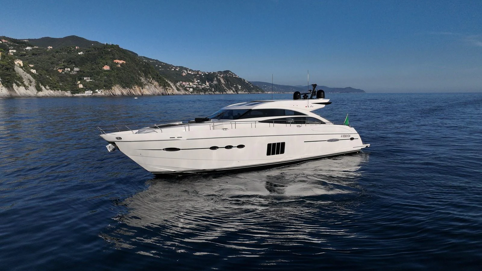 A sleek white yacht cruises gracefully on calm waters with a scenic coastal backdrop. aboard GIA GIA' Yacht for Sale