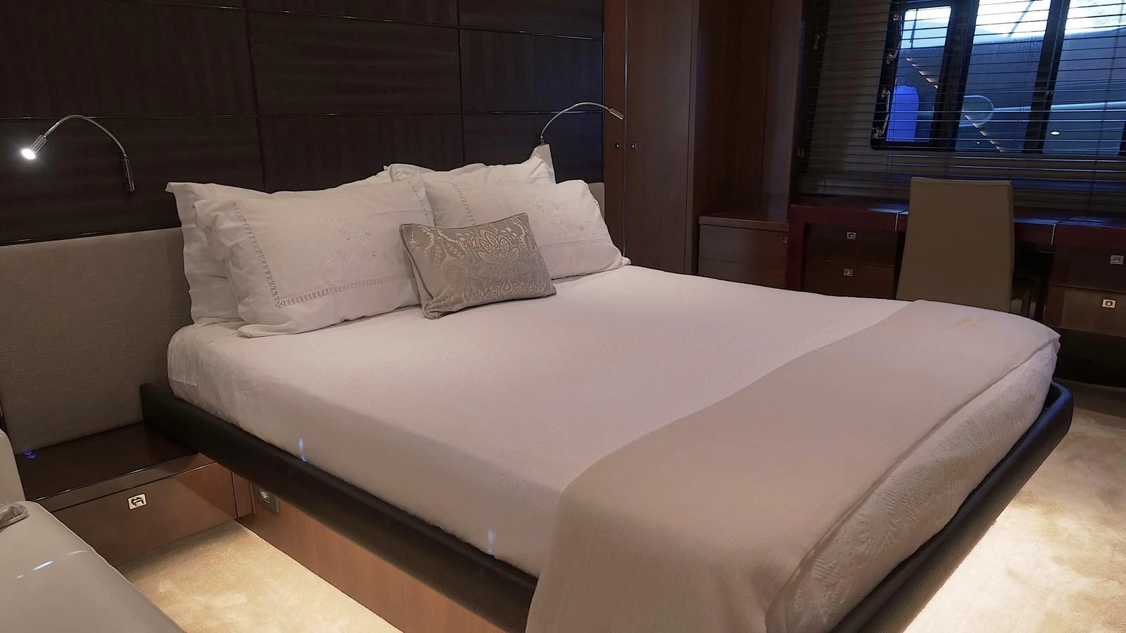 The stateroom features a luxurious bed with elegant bedding and modern lighting. aboard GIA GIA' Yacht for Sale