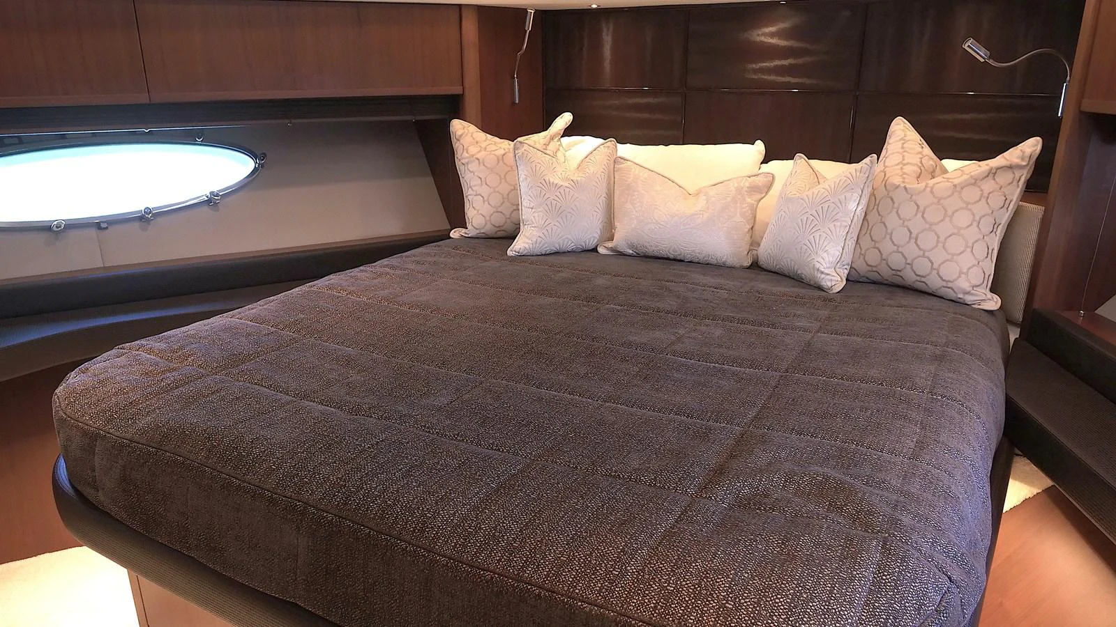 The stateroom features a large, comfortable bed with plush pillows and elegant wood paneling. aboard GIA GIA' Yacht for Sale