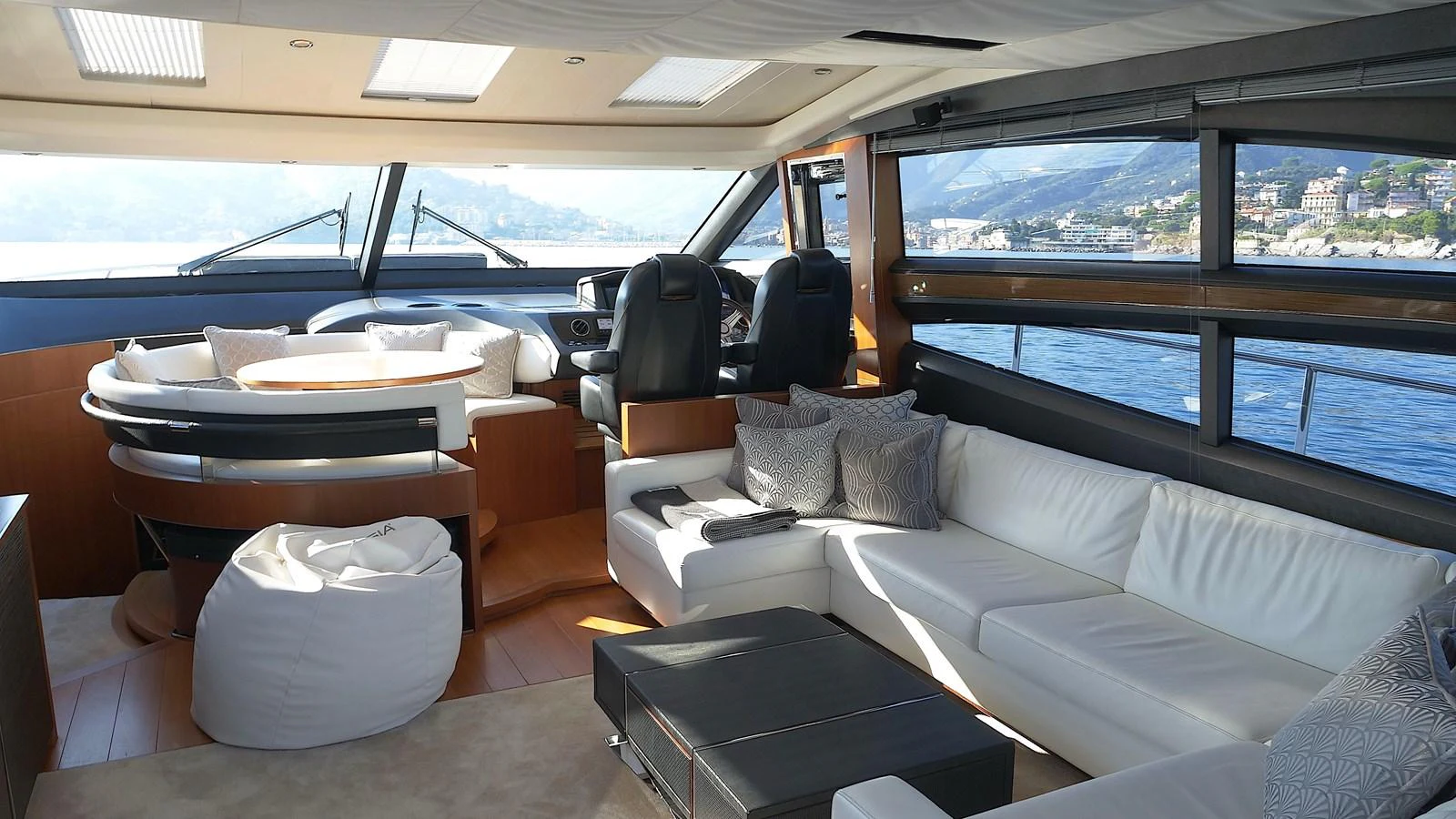The salon features a spacious seating area with panoramic windows offering stunning ocean views. aboard GIA GIA' Yacht for Sale