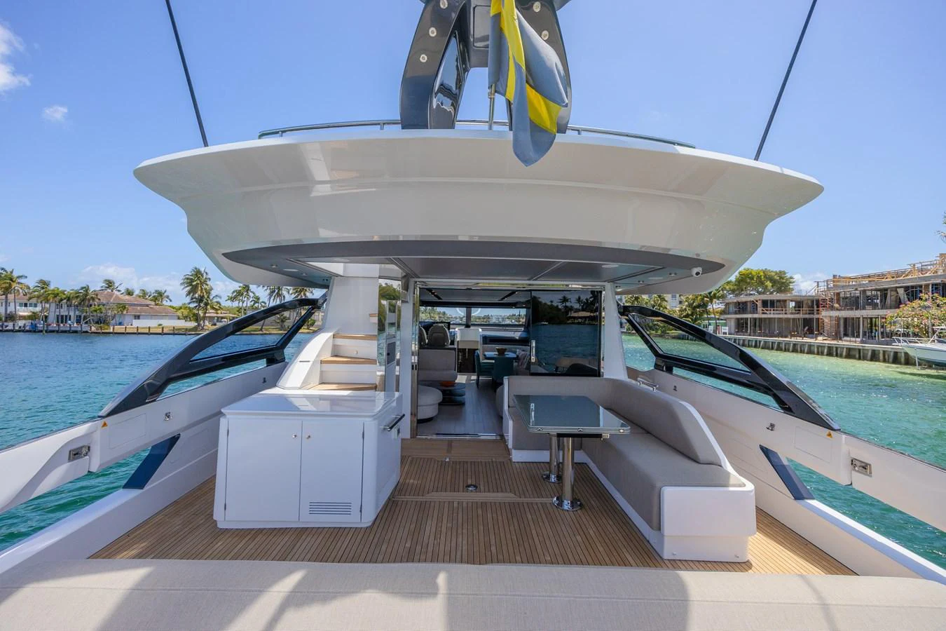 The aft deck offers a spacious and inviting area for relaxation and socializing with a beautiful view of the water. aboard NO TIME TO DIE Yacht for Sale