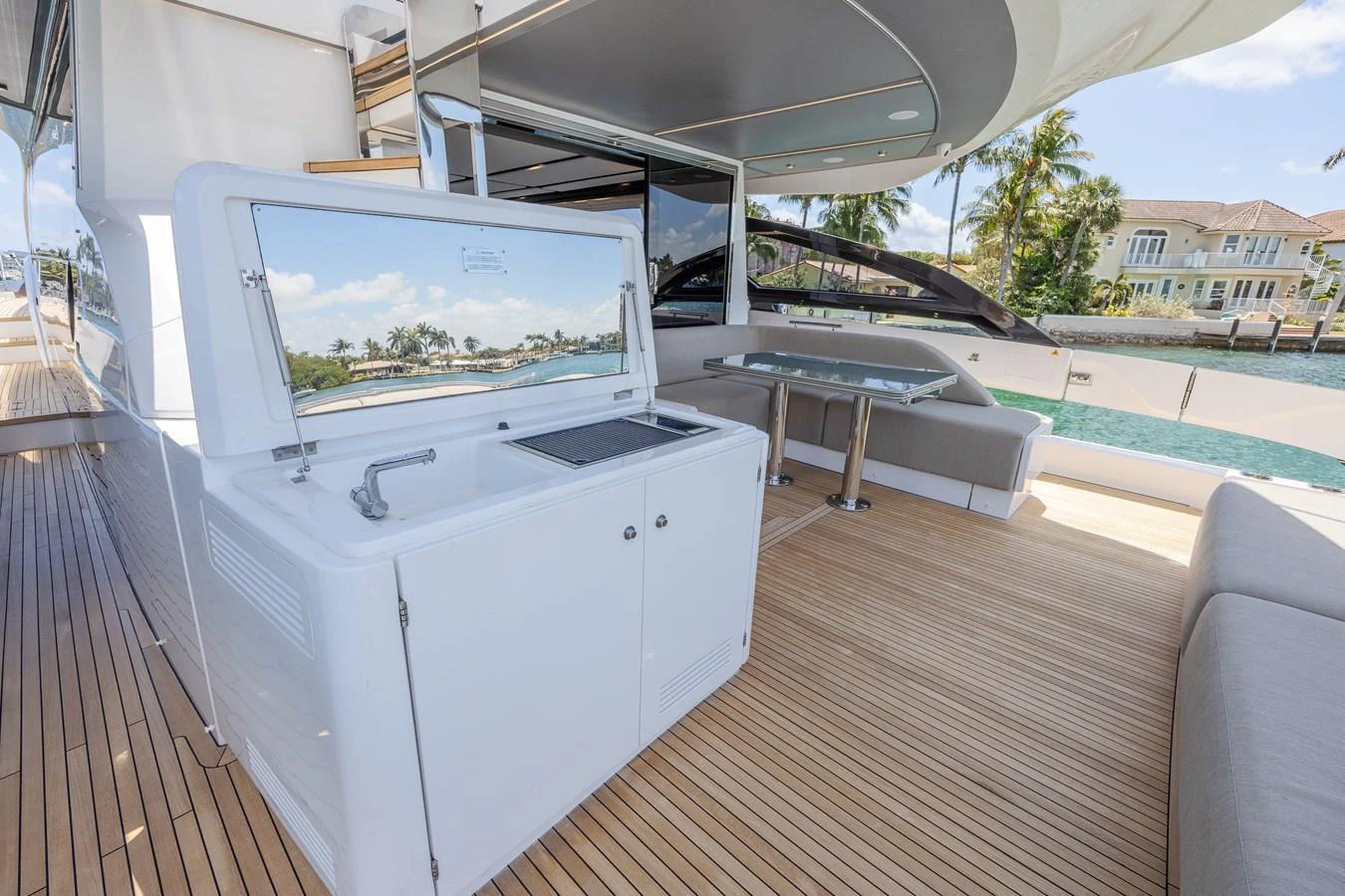 The aft deck features a sleek wet bar and a comfortable seating area with a view of the water. aboard NO TIME TO DIE Yacht for Sale