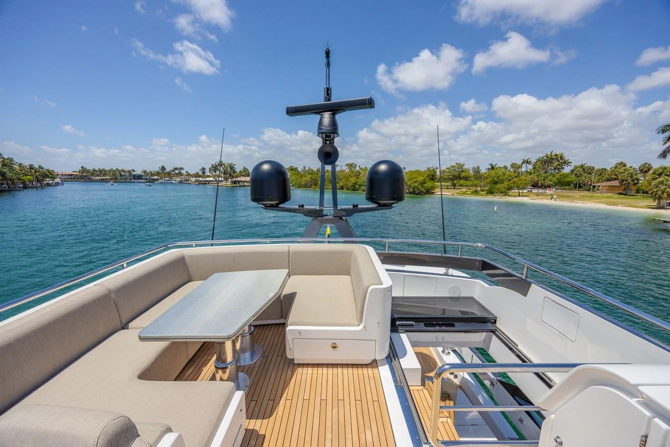 The flybridge offers a spacious seating area with a table, perfect for enjoying scenic views. aboard NO TIME TO DIE Yacht for Sale