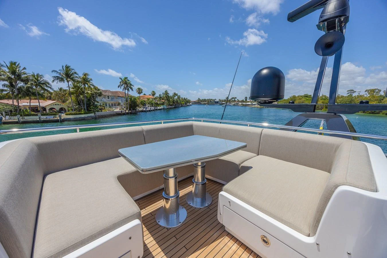 The flybridge features a comfortable seating area with a sleek table, perfect for enjoying scenic views. aboard NO TIME TO DIE Yacht for Sale
