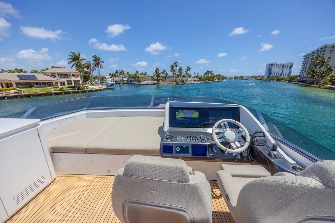 The helm station offers a commanding view of the serene waters and surrounding landscape. aboard NO TIME TO DIE Yacht for Sale