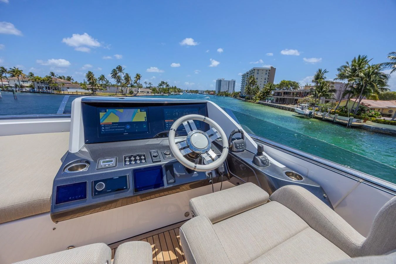 The helm station offers a commanding view with state-of-the-art navigation equipment and plush seating. aboard NO TIME TO DIE Yacht for Sale