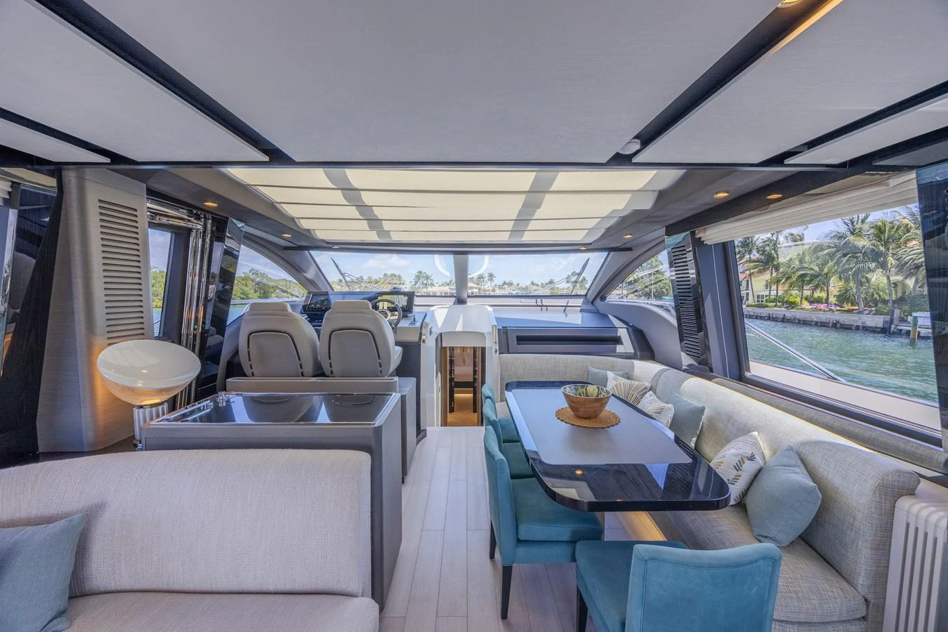 The yacht's salon features a spacious and modern design with ample seating and large windows offering stunning views. aboard NO TIME TO DIE Yacht for Sale