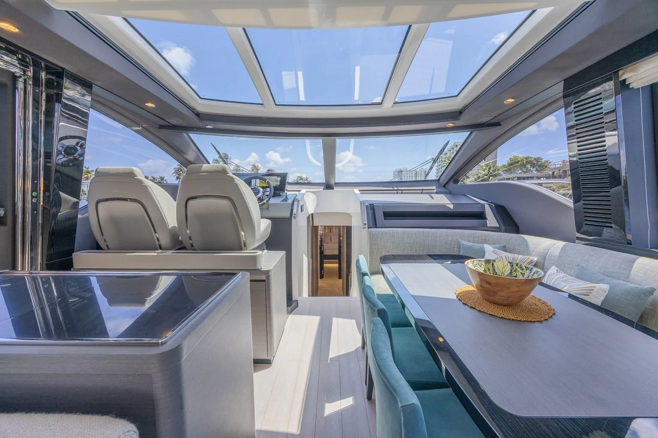 The yacht's saloon features a modern design with ample natural light from the large skylights. aboard NO TIME TO DIE Yacht for Sale