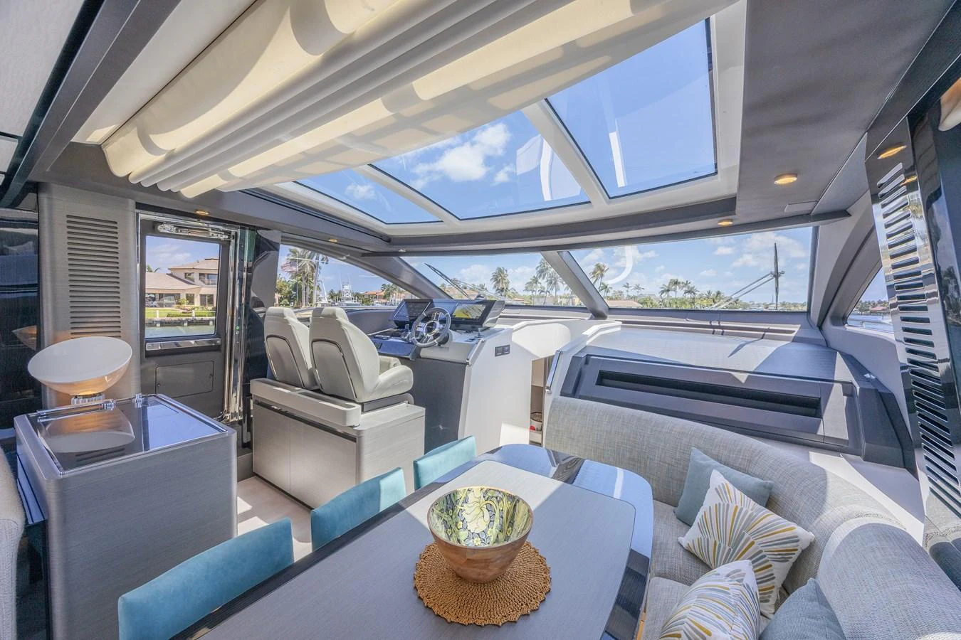 The salon features a spacious seating area with large windows and a skylight, offering a bright and airy atmosphere. aboard NO TIME TO DIE Yacht for Sale