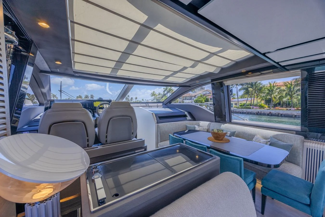 The yacht's helm area features a sleek design with comfortable seating and ample natural light. aboard NO TIME TO DIE Yacht for Sale