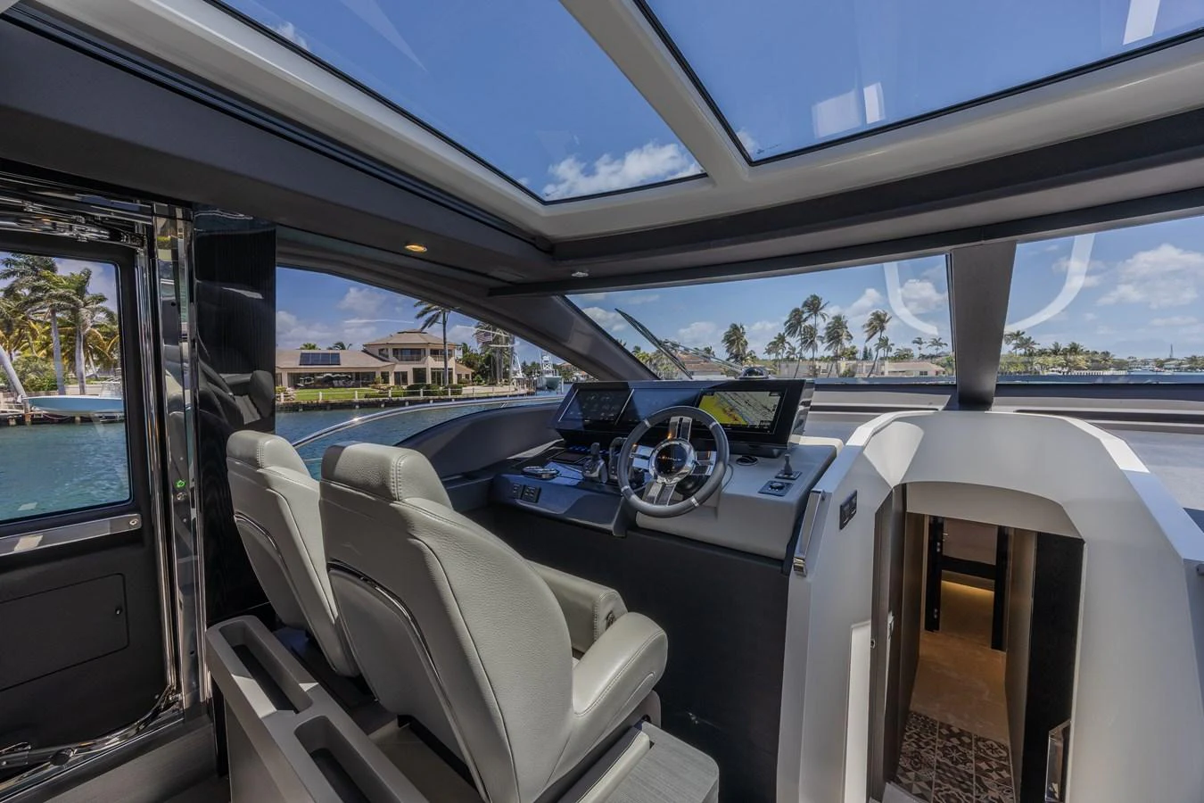 The helm station offers a sleek and modern design with panoramic views through large windows. aboard NO TIME TO DIE Yacht for Sale
