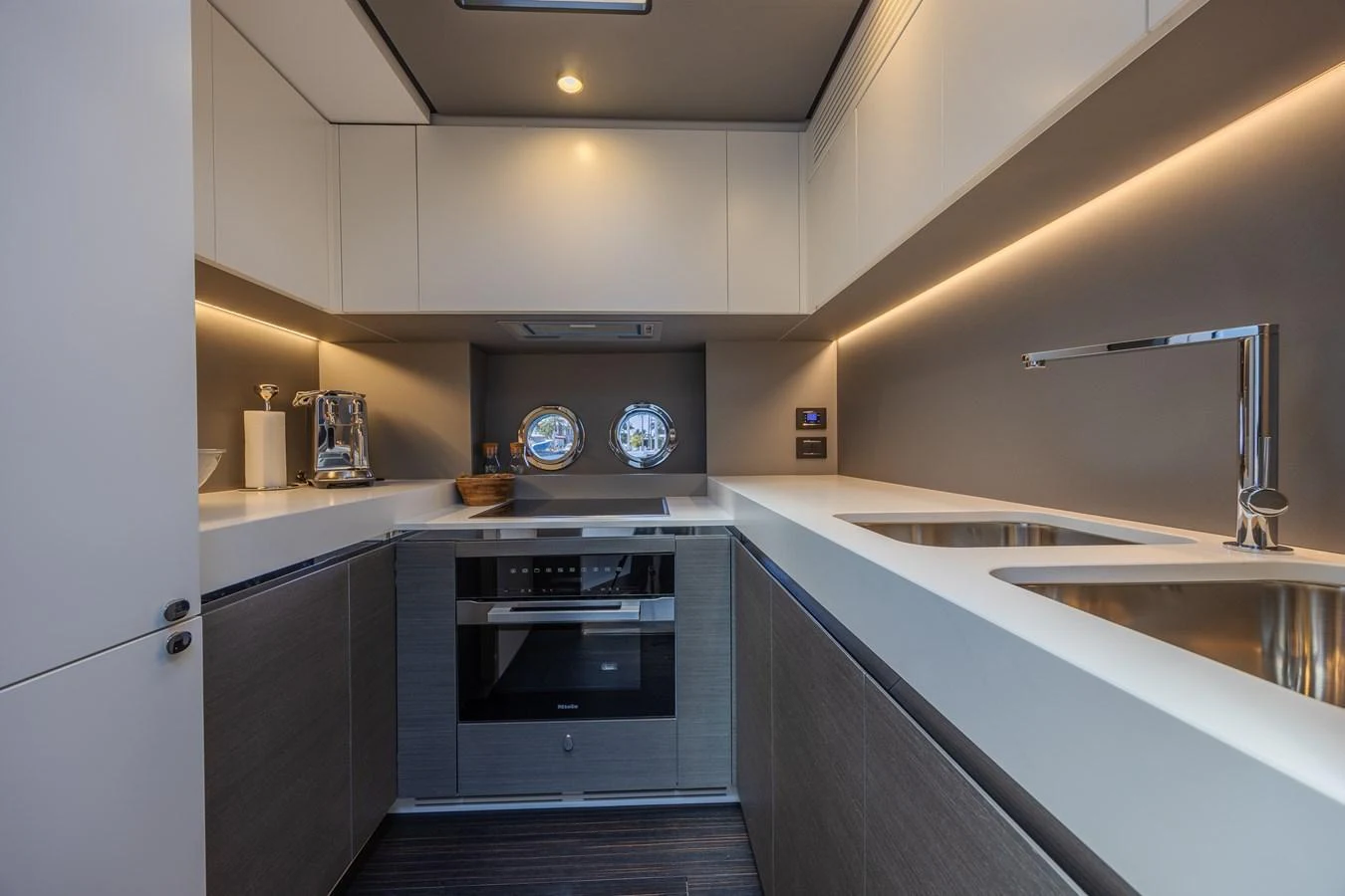 The yacht's galley features modern appliances and sleek design, perfect for gourmet meal preparation. aboard NO TIME TO DIE Yacht for Sale