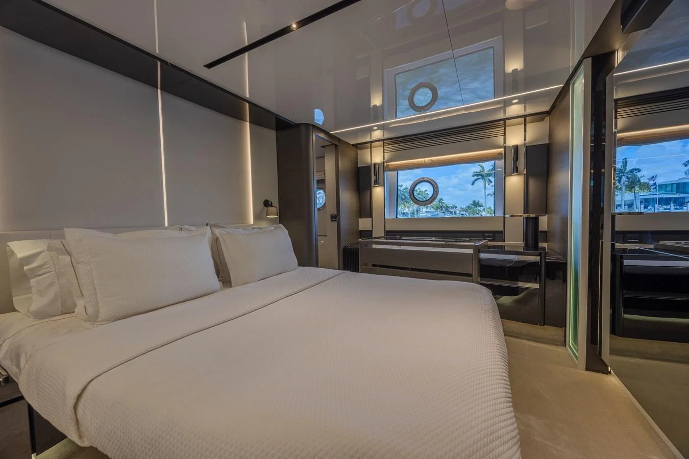 The stateroom features a luxurious bed with elegant linens and modern decor, offering a serene retreat. aboard NO TIME TO DIE Yacht for Sale
