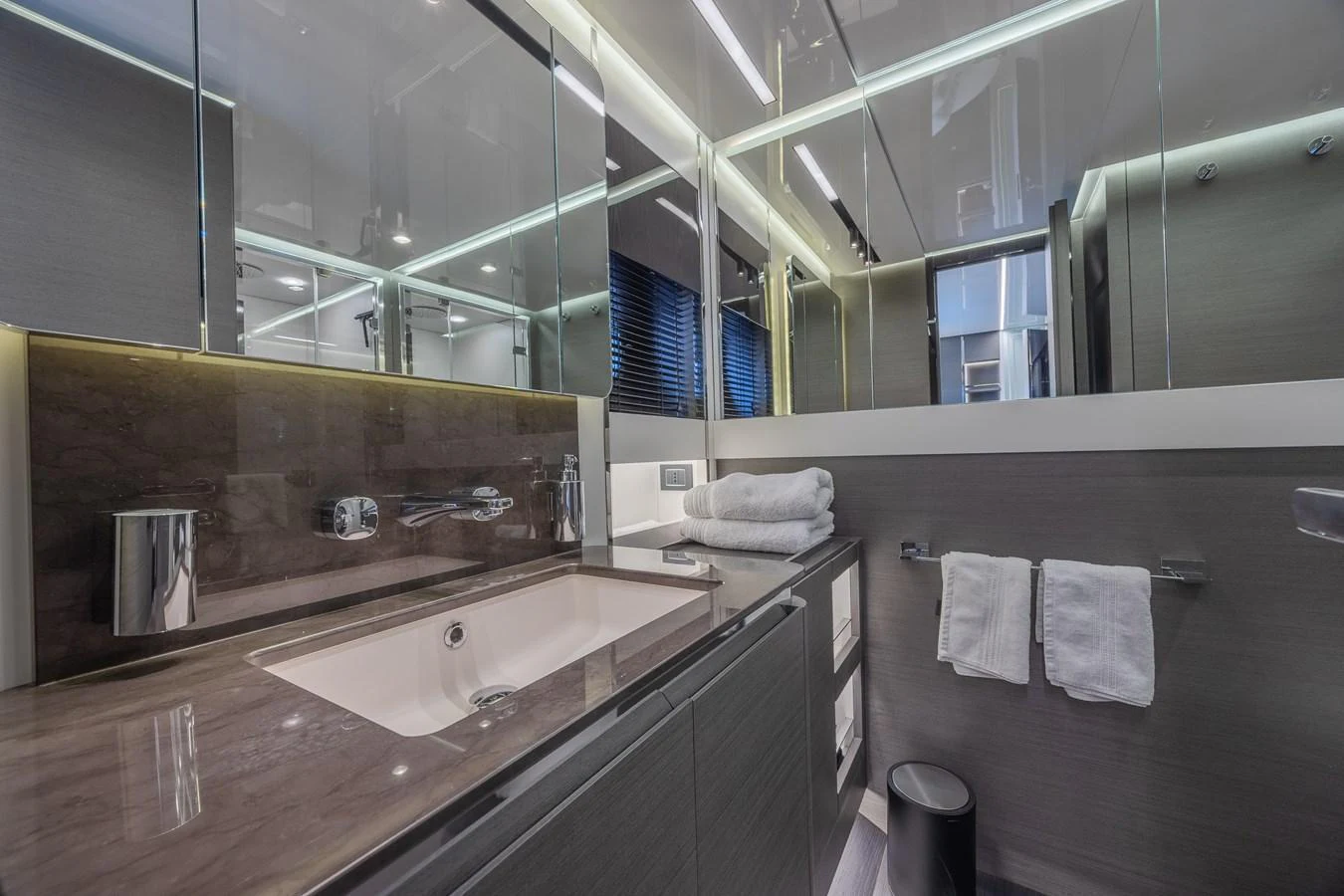 The yacht's bathroom features sleek modern design with high-end fixtures and ample lighting. aboard NO TIME TO DIE Yacht for Sale