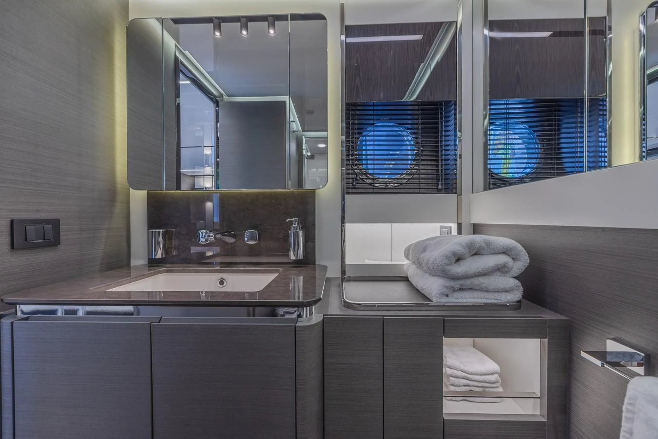 The yacht's bathroom features modern fixtures and a sleek design with ample storage space. aboard NO TIME TO DIE Yacht for Sale