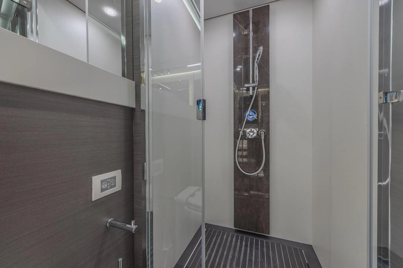 A sleek and modern yacht shower with contemporary fixtures. aboard NO TIME TO DIE Yacht for Sale