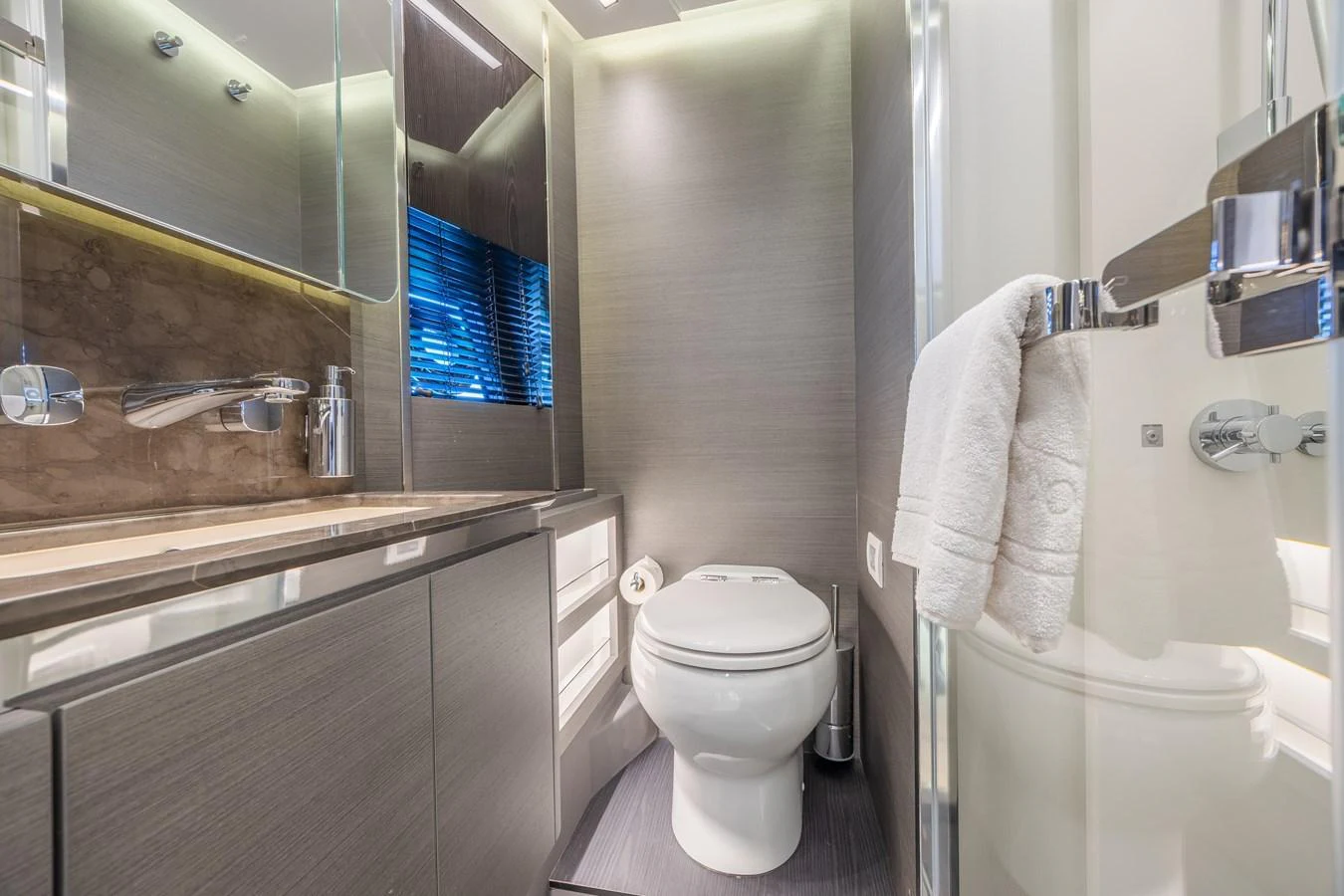 The yacht's bathroom features modern fixtures and sleek design elements. aboard NO TIME TO DIE Yacht for Sale