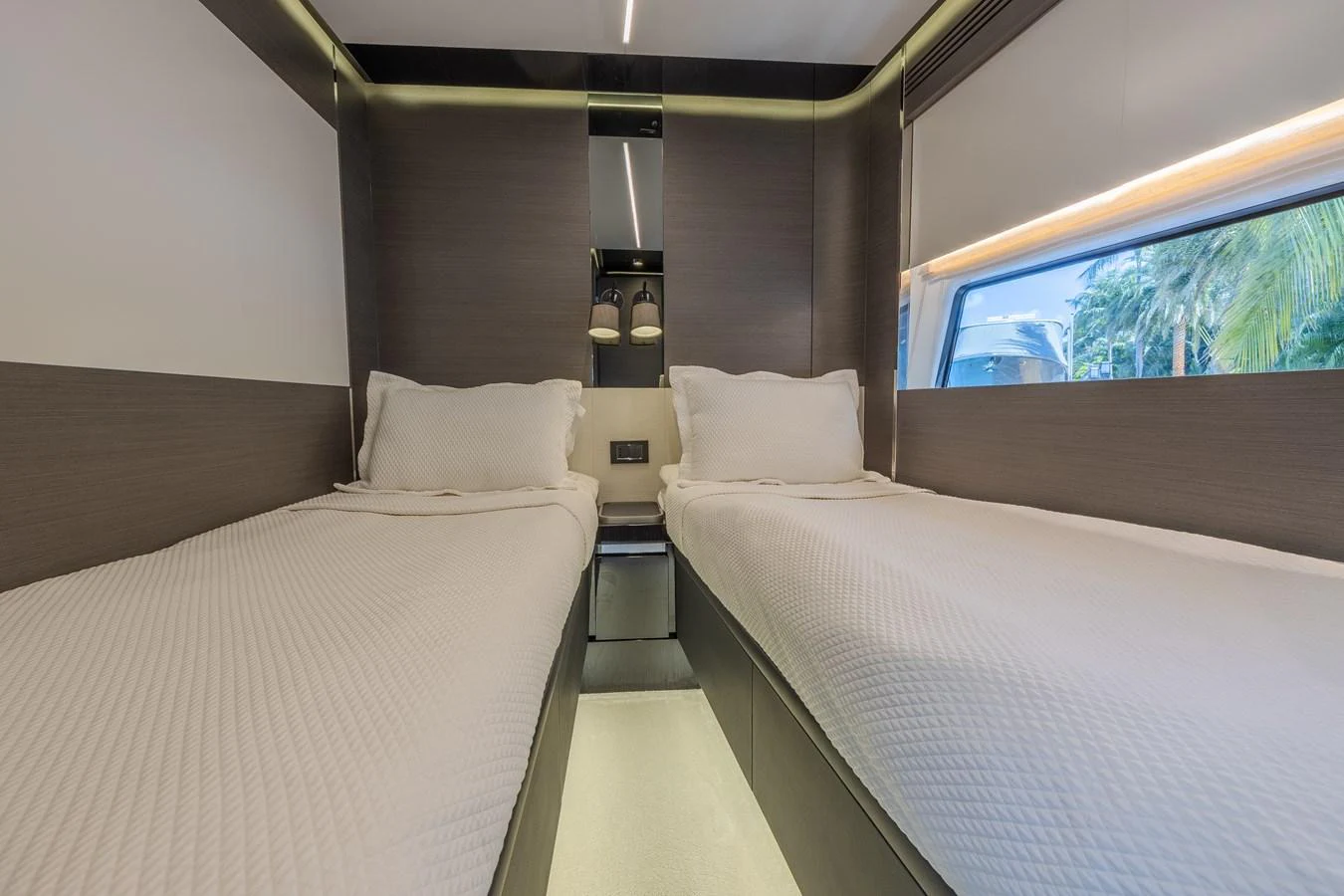 A modern twin stateroom with sleek design and ample natural light. aboard NO TIME TO DIE Yacht for Sale