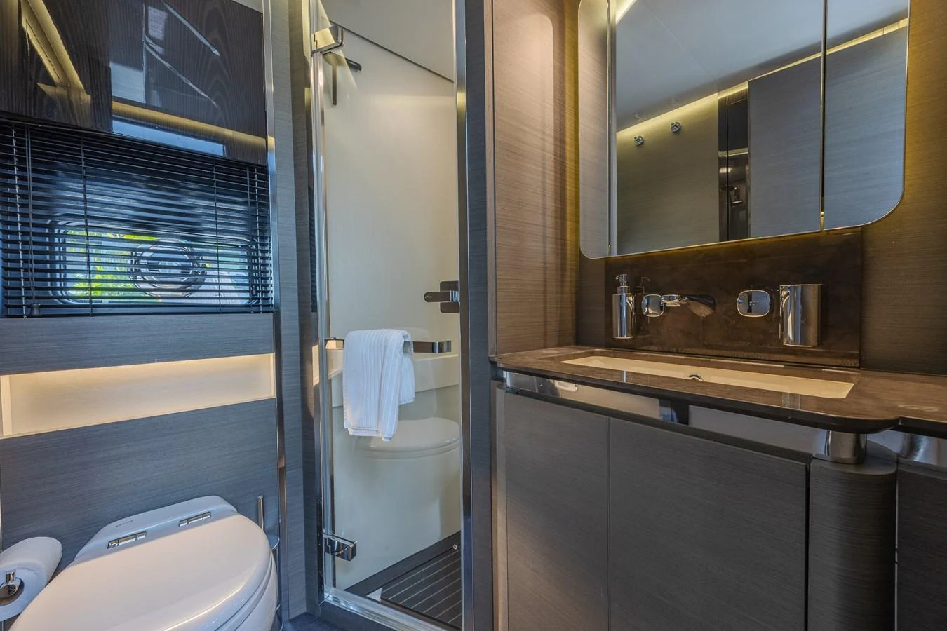 A sleek and modern bathroom with a glass-enclosed shower and stylish fixtures. aboard NO TIME TO DIE Yacht for Sale