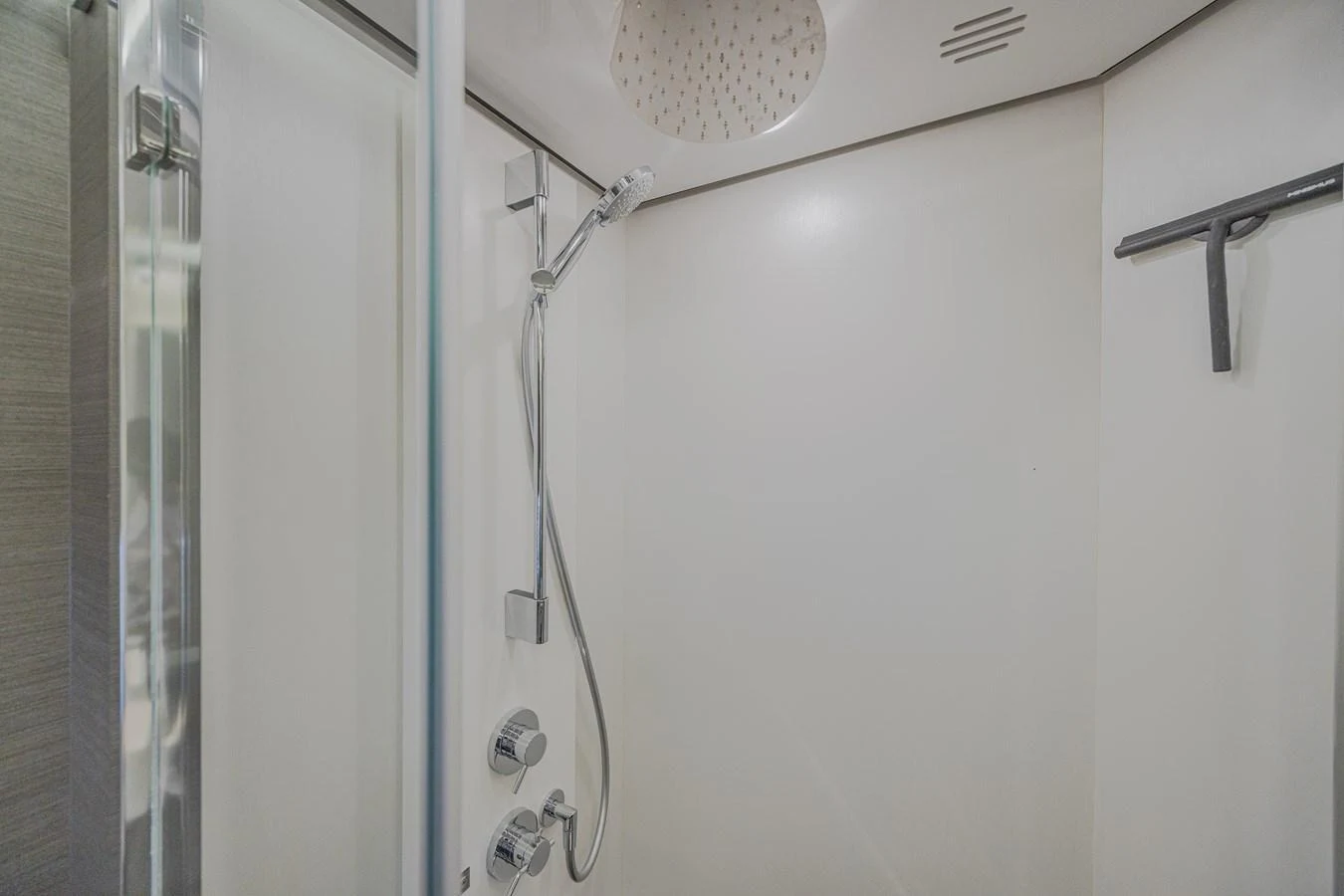 The yacht features a sleek and modern shower area with high-end fixtures. aboard NO TIME TO DIE Yacht for Sale