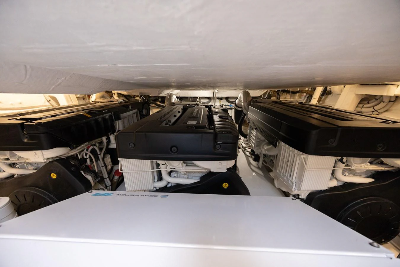 The image showcases the yacht's engine room with powerful engines neatly installed. aboard NO TIME TO DIE Yacht for Sale