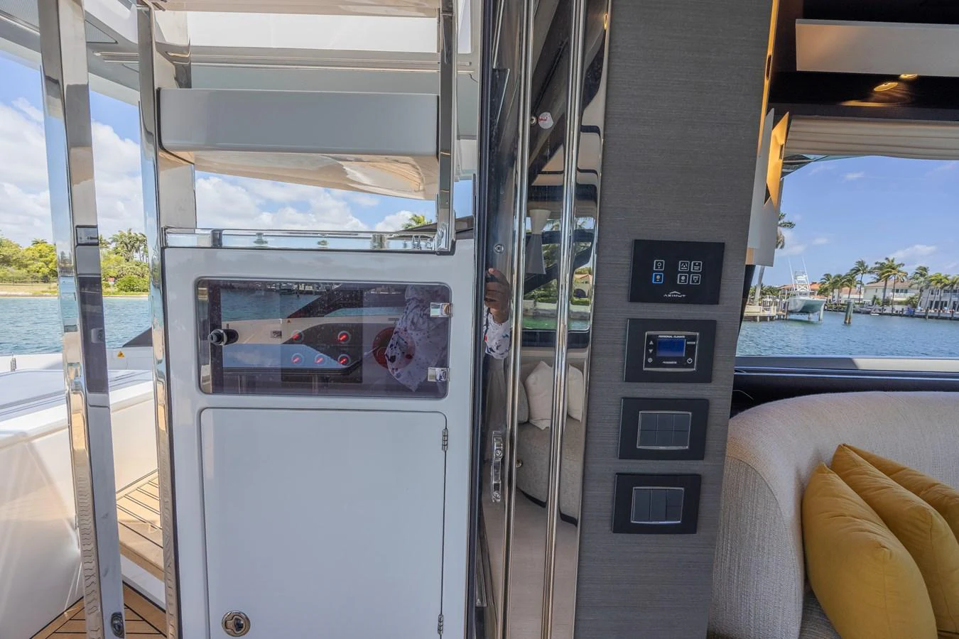 This image showcases a modern interior area of the yacht with a view of the outside through large windows. aboard NO TIME TO DIE Yacht for Sale