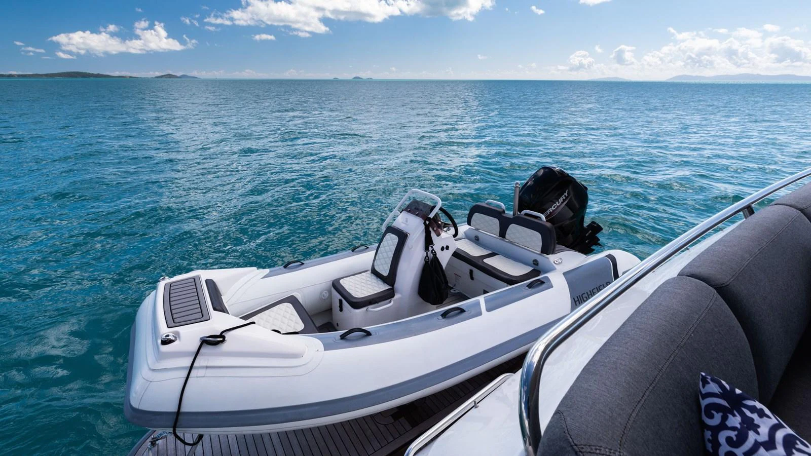 A sleek tender is docked beside the yacht, ready for excursions on the open water. aboard ABOUT TIME Yacht for Sale