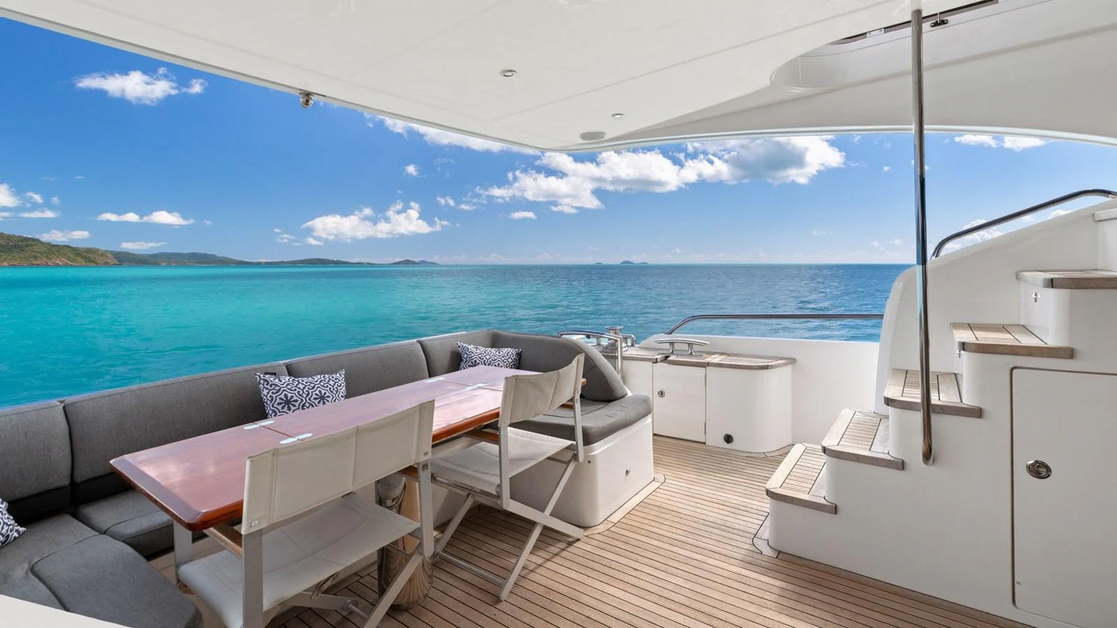 The aft deck offers a spacious and comfortable seating area with stunning ocean views. aboard ABOUT TIME Yacht for Sale
