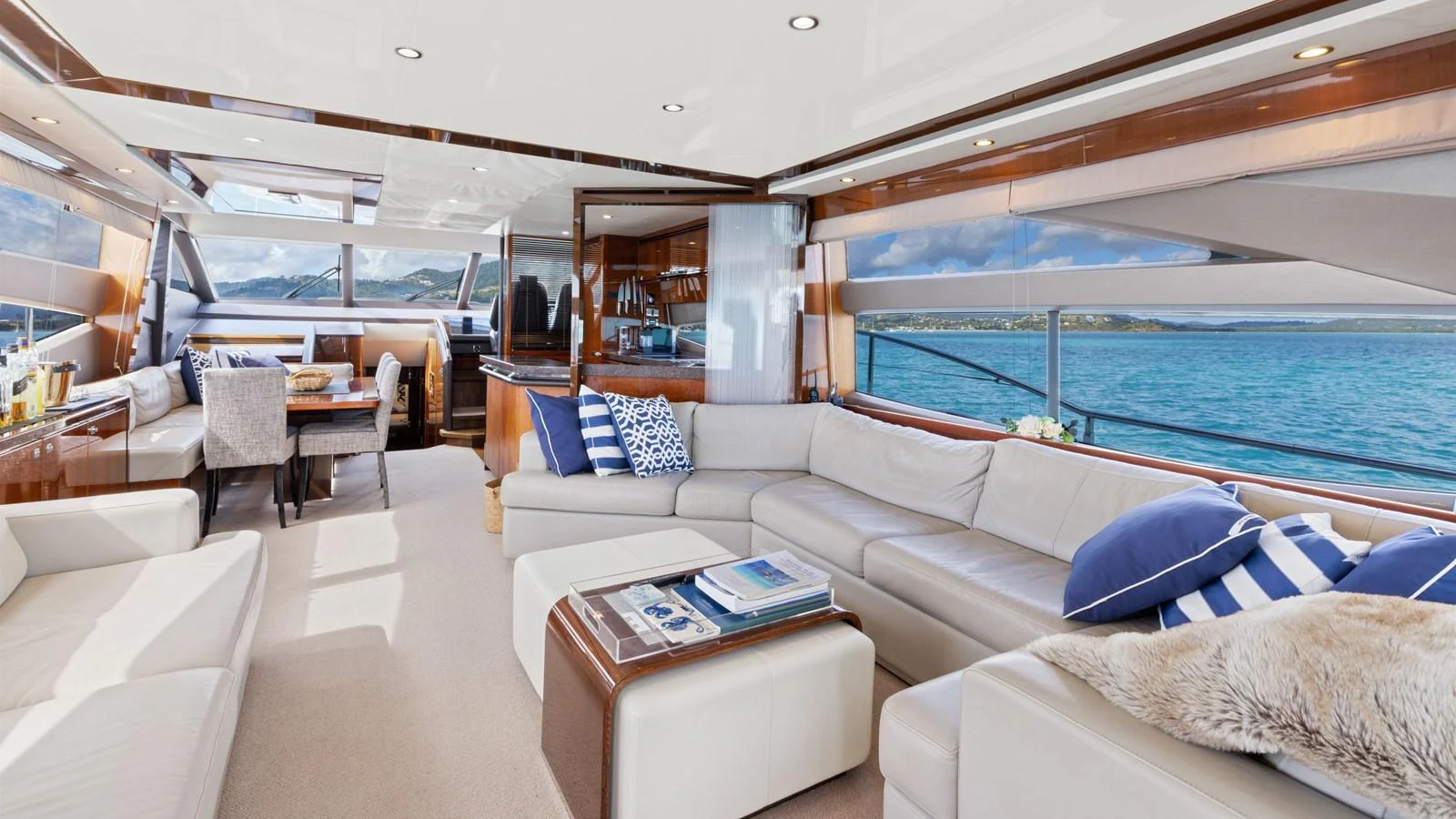 The yacht's salon offers a spacious and luxurious seating area with panoramic ocean views. aboard ABOUT TIME Yacht for Sale