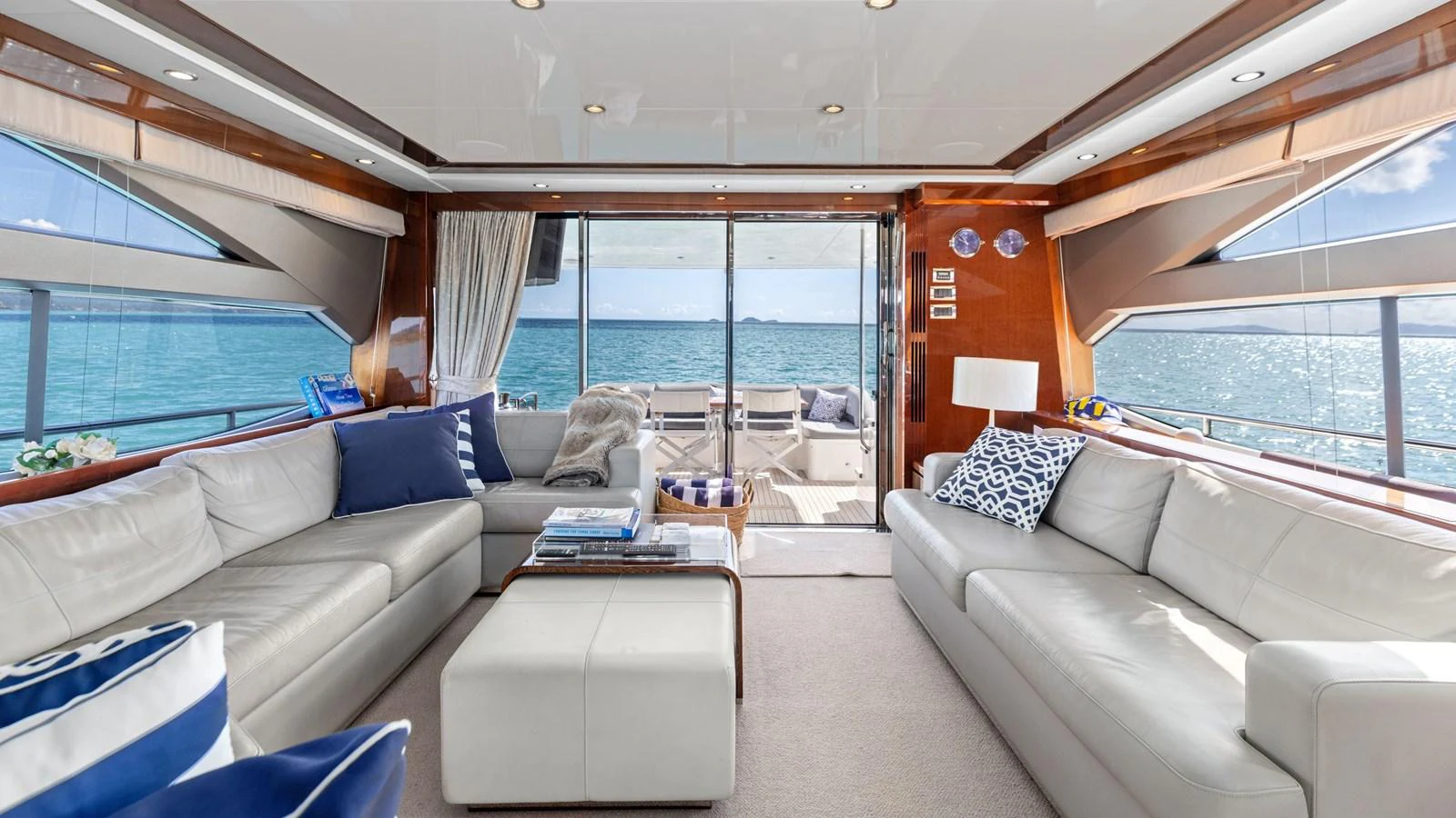 The salon offers a spacious and luxurious seating area with stunning ocean views through large windows. aboard ABOUT TIME Yacht for Sale