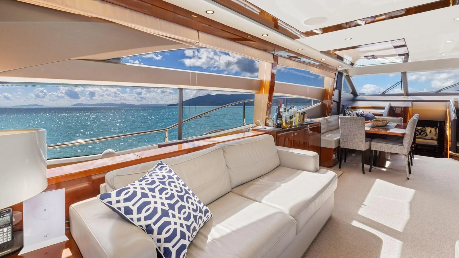 The salon offers a spacious and luxurious seating area with panoramic ocean views. aboard ABOUT TIME Yacht for Sale