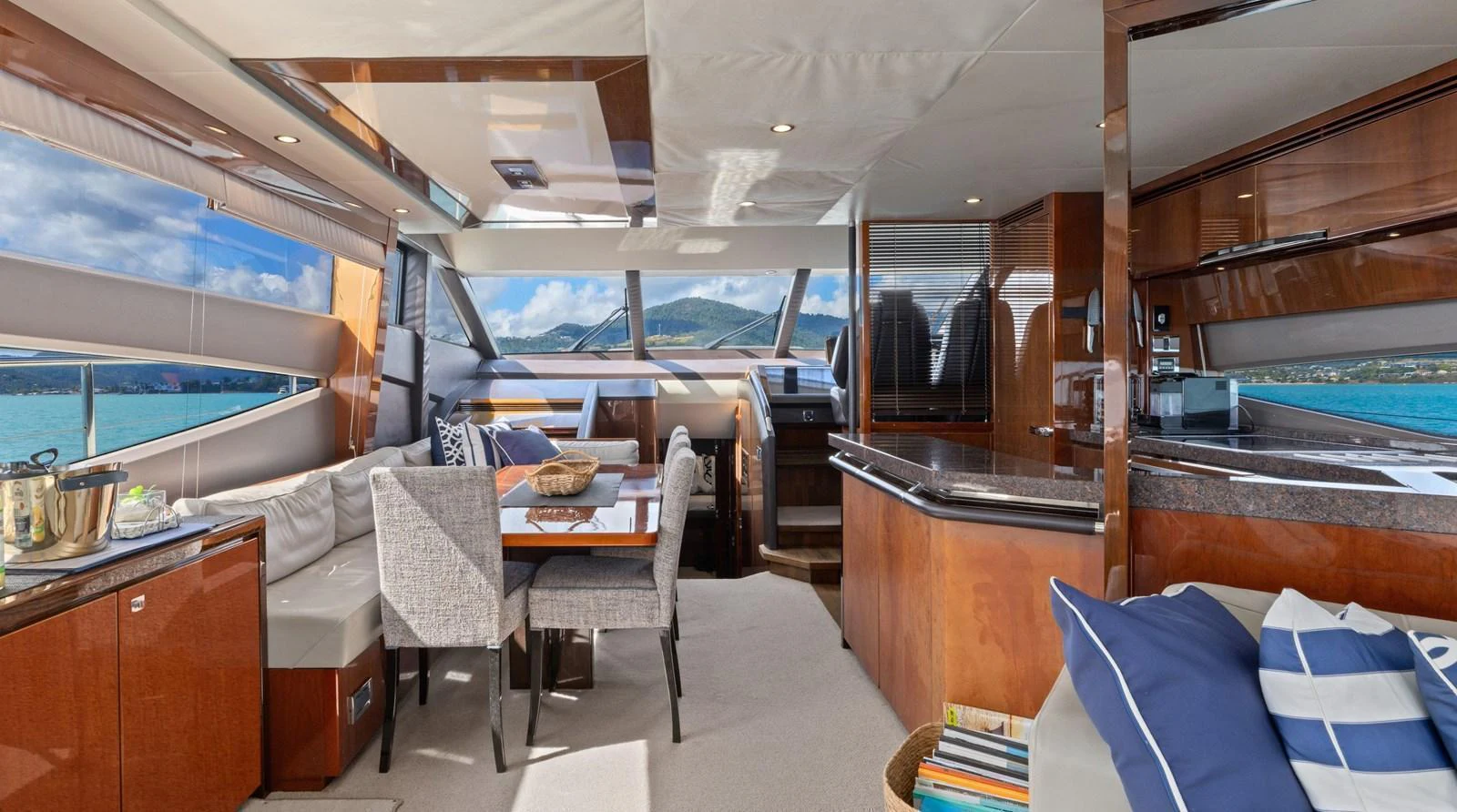 The salon offers a spacious and elegant area with panoramic windows and luxurious furnishings. aboard ABOUT TIME Yacht for Sale