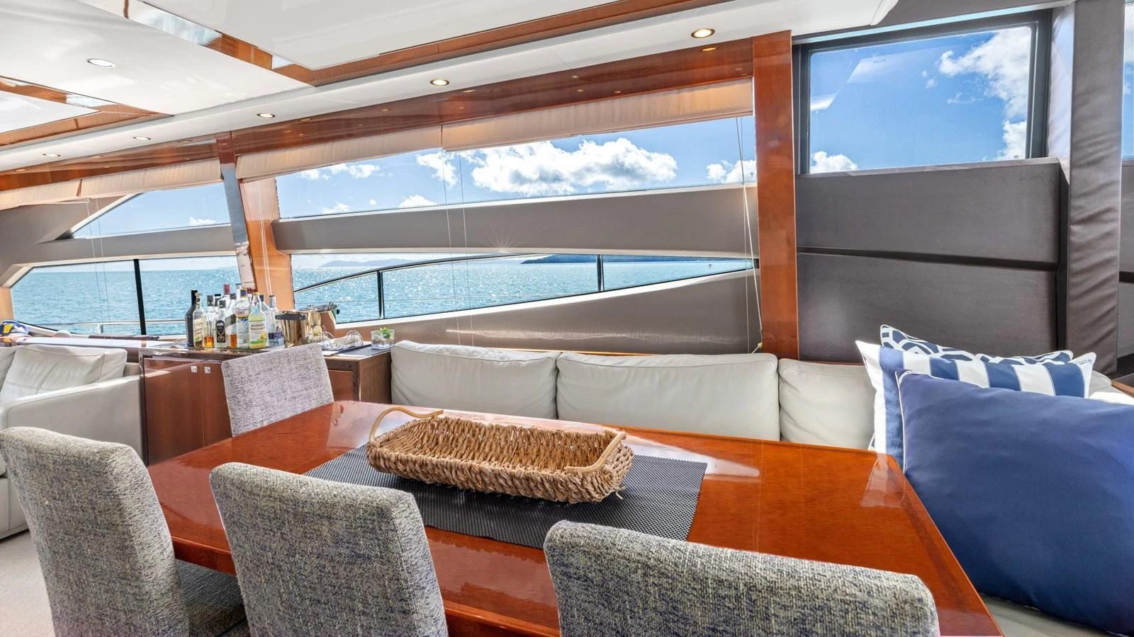 The salon offers a luxurious and comfortable space with large windows providing stunning ocean views. aboard ABOUT TIME Yacht for Sale