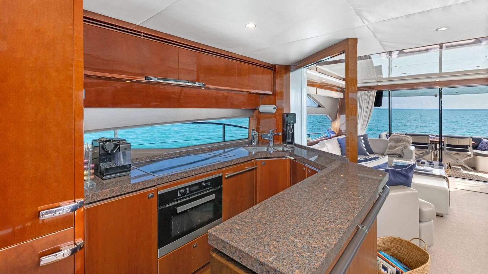 The yacht's galley features modern appliances and a sleek design with a view of the sea. aboard ABOUT TIME Yacht for Sale