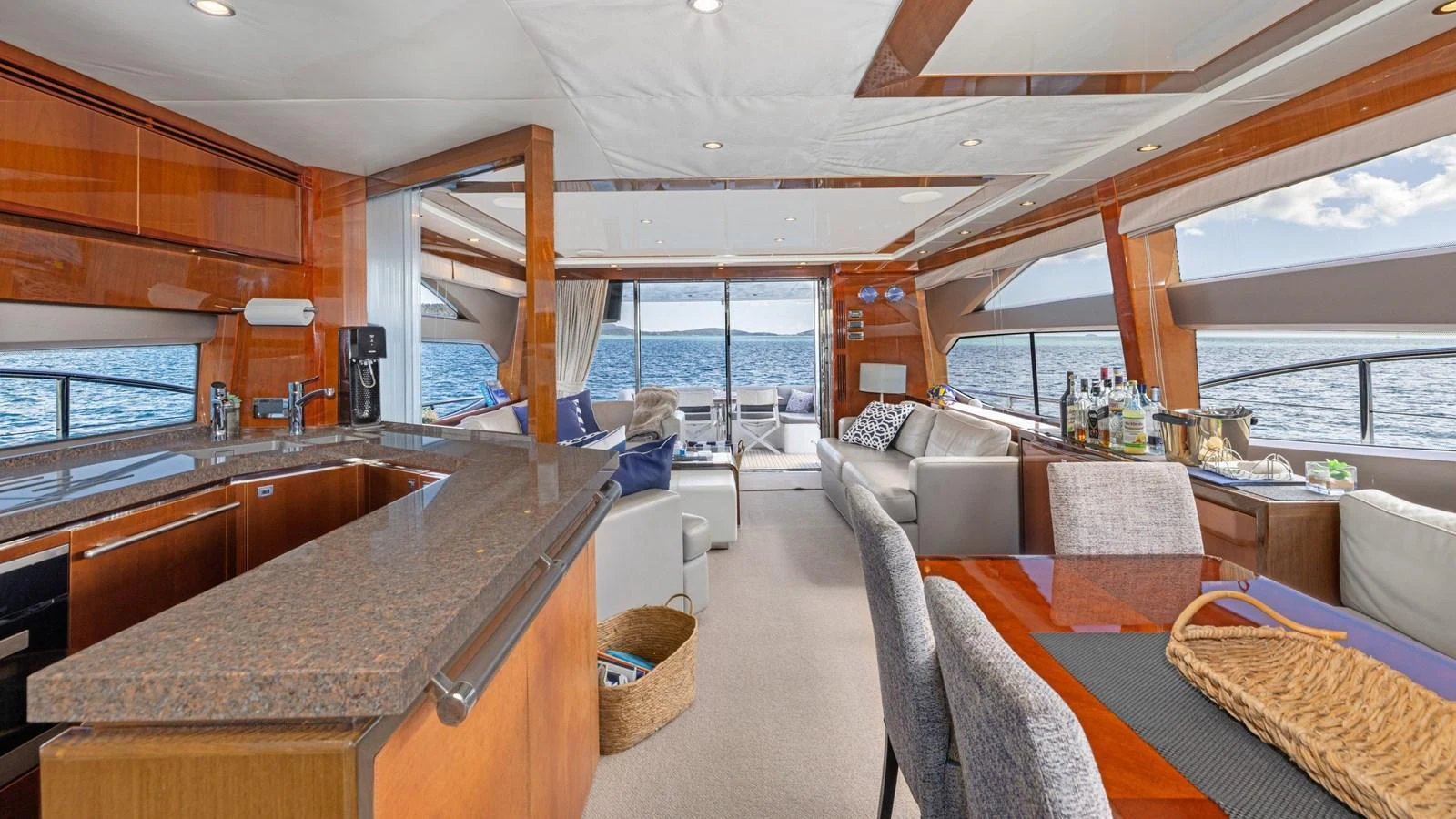 The salon offers a spacious and elegant setting with panoramic views and luxurious furnishings. aboard ABOUT TIME Yacht for Sale