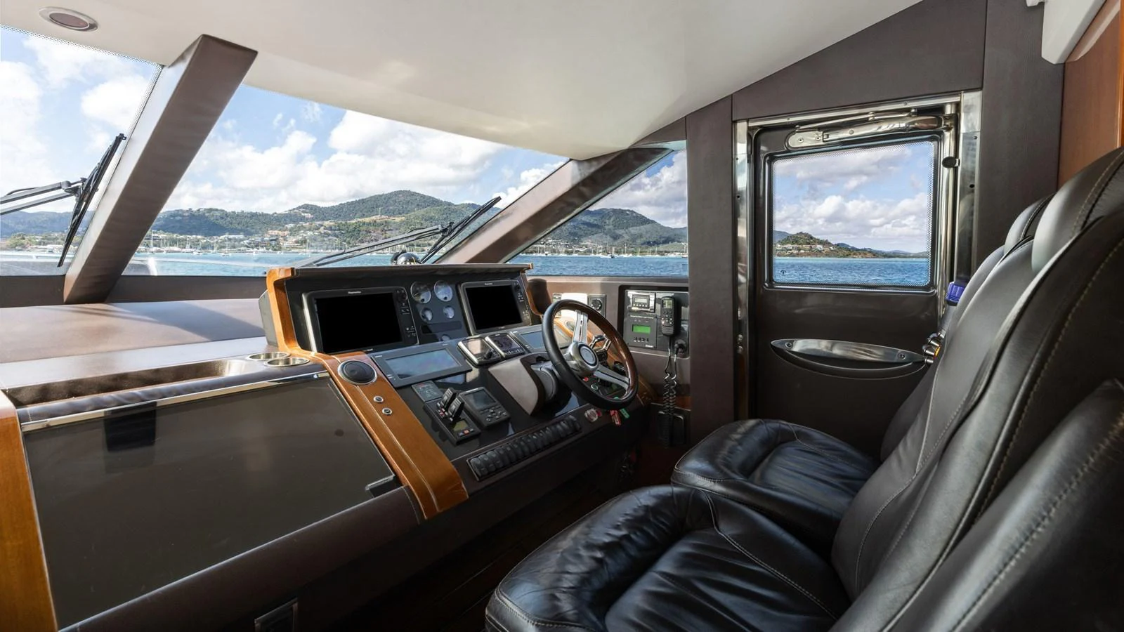 The helm of this yacht offers a luxurious and modern command center with stunning views. aboard ABOUT TIME Yacht for Sale
