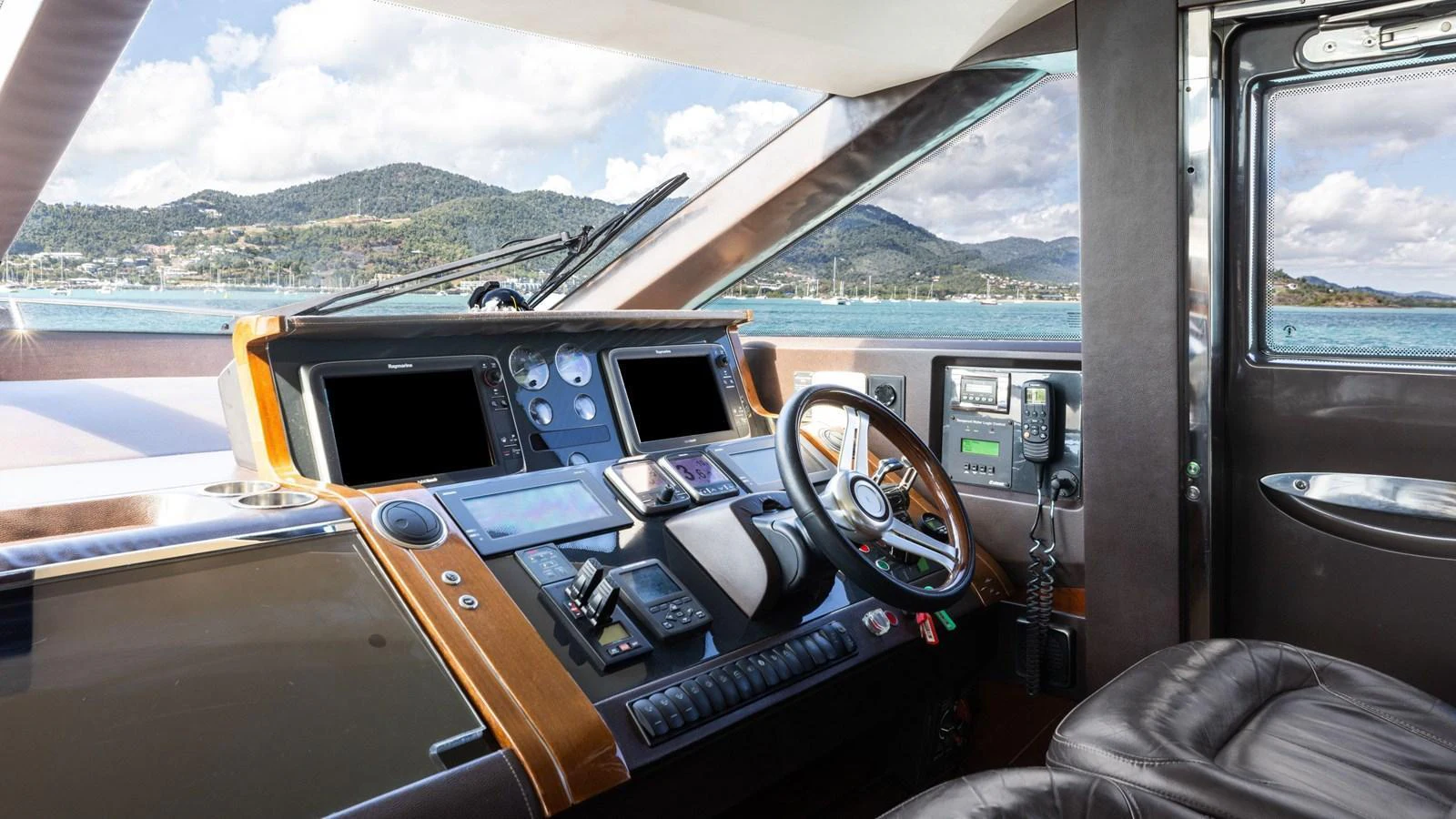The helm station offers a sophisticated and well-equipped control area with panoramic views. aboard ABOUT TIME Yacht for Sale